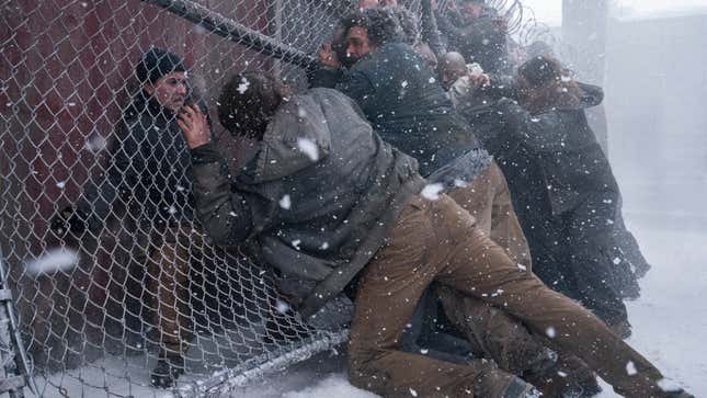 Abby cowers behind a collapsed fence as infected try to reach her.