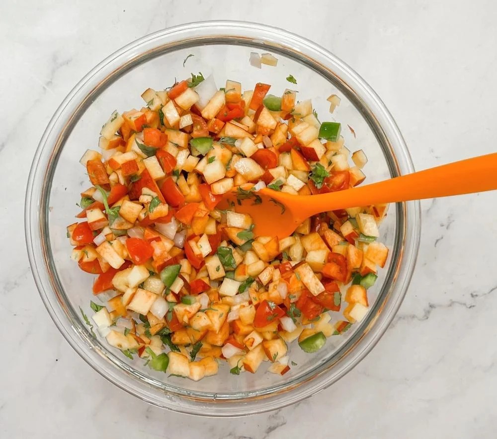Mixing up peach salsa ingredients
