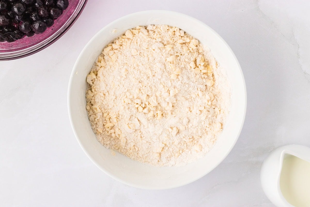 Gluten-free flour mixture with small chunks of butter cut in, ready for wet ingredients to be added.