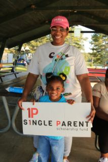 ASPSF recipient and her daughter hold an ASPSF sign