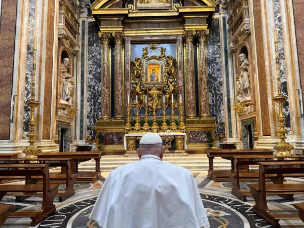 Pope Francis kneels in prayer before the revered Marian icon