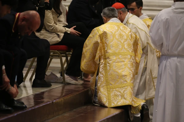 Cardinal Mauro Gambetti kneels to wash the feet of laypeople during the traditional Holy Thursday ritual at St. Peter's Basilica, Vatican City, April 17, 2025. Zofia Czubak / EWTN News
