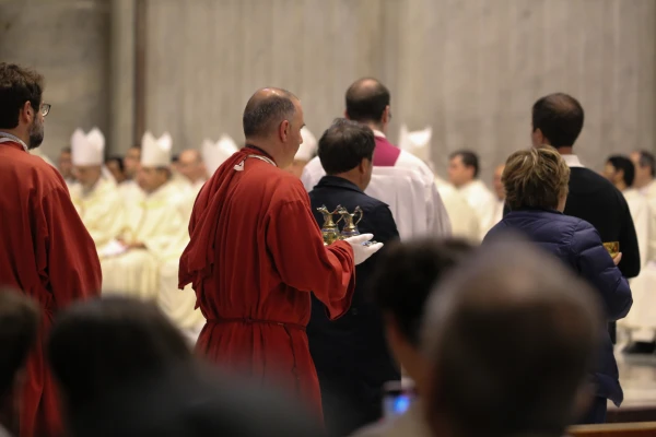 Clergy carry vessels with water and towels for the foot washing ritual during Holy Thursday Mass at St. Peter's Basilica in Vatican City, April 17, 2025. Zofia Czubak / EWTN News