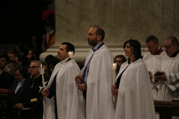 Three catechumens are seen during the Easter Vigil at St. Peter's Basilica, Saturday, April 19, 2025. Credit: Zosia Czubak