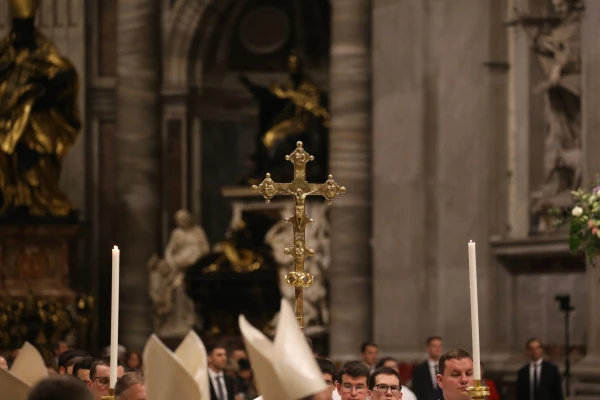 A crucifix is held aloft during the Easter Vigil at St. Peter’s Basilica, Saturday, April 19, 2025. Credit: Zosia Czubak