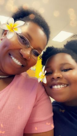 Selfie with flower filter of Ronisha Niki Baker and her youngest daughter