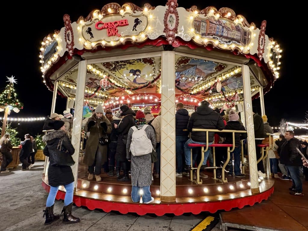 A Christmas-themed bar carousel at a market.