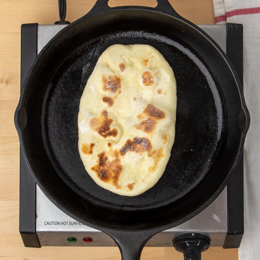 same dough now as cooked gluten free naan bread with bubbles and brown spots