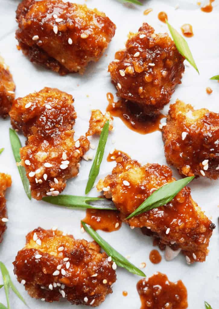Overhead shot of chicken nuggets on a white surface.