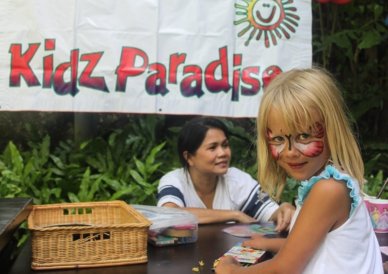 child with painted face smiling at Kids club Thailand