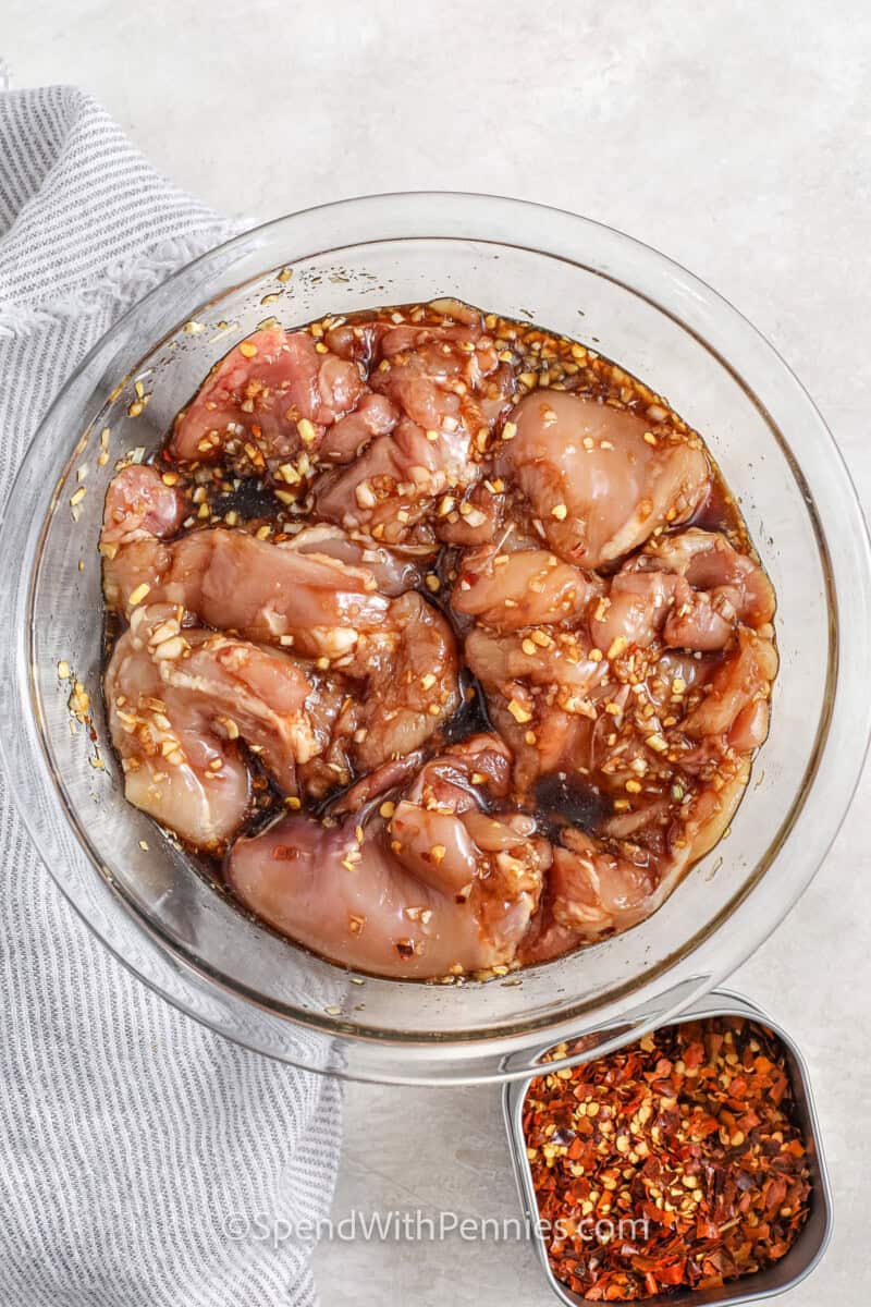 adding marinade to Chicken to make Lemongrass Chicken