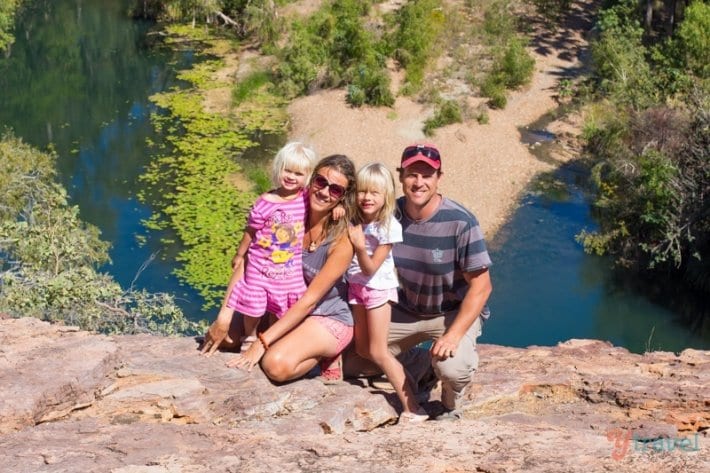 family posing in edge of cliff