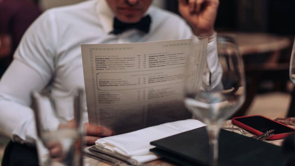 Man looking at menu. 