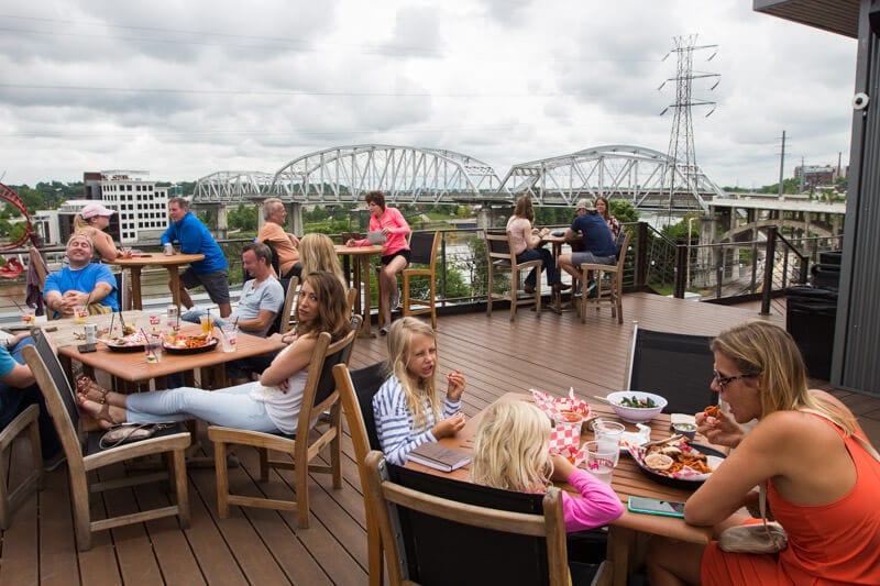 family eating on terrace of acme rooftop