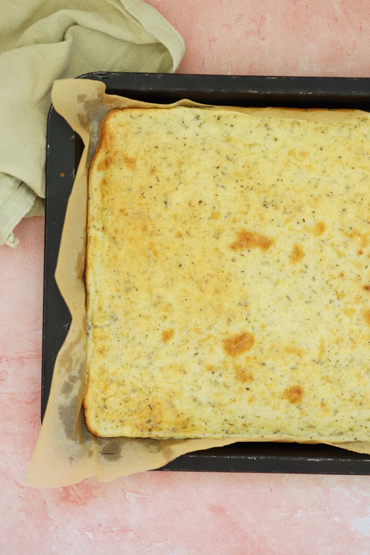 A cottage cheese flatbread in a baking tin.