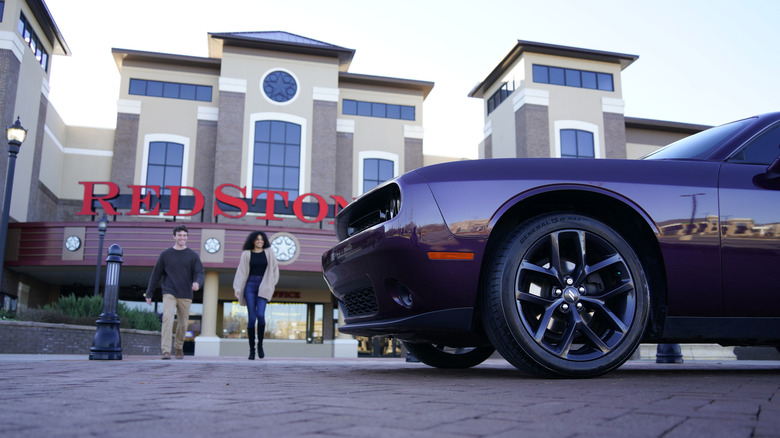 Couple walking out to their purple car