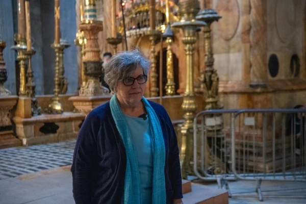 Professor Francesca Romana Stasolla, director of the Department of Antiquities at the University La Sapienza in Rome and director of the ongoing archaeological excavations in the Basilica of the Holy Sepulcher in Jerusalem, stands in front of the edicule that houses the venerated tomb. Credit: Marinella Bandini
