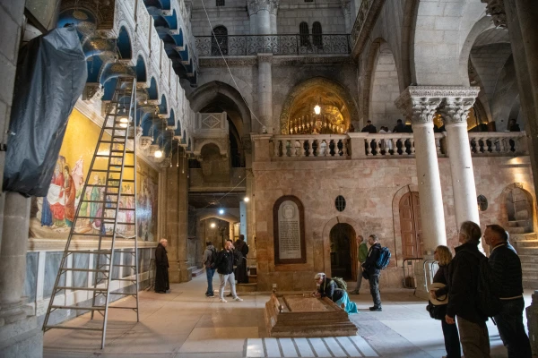 The interior of the Basilica of the Holy Sepulcher in Jerusalem. In the center, the Stone of Anointing, with Calvary in the background. Credit: Marinella Bandini