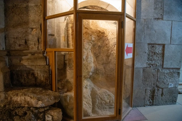 A portion of the Rock of Calvary in the Basilica of the Holy Sepulcher in Jerusalem. The rock is visible along the basilica’s ambulatory and at the top through a glass panel in the Greek Orthodox chapel. Credit: Marinella Bandini