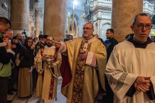After blessing the water, Cardinal Pierbattista Pizzaballa, the Latin patriarch of Jerusalem, blesses the faithful during the Easter Vigil celebrated on the morning of Saturday, March 30, 2024, in the Basilica of the Holy Sepulcher in Jerusalem. Credit: Marinella Bandini