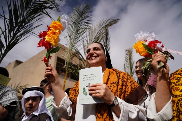 As they walked through the streets of Qaraqosh, Iraq, on April 13, 2025, participants sang Palm Sunday hymns in both Arabic and Syriac, waving olive branches and many wearing traditional attire from Qaraqosh and other Christian towns and villages in Iraq. Credit: Ismael Adnan/ACI MENA