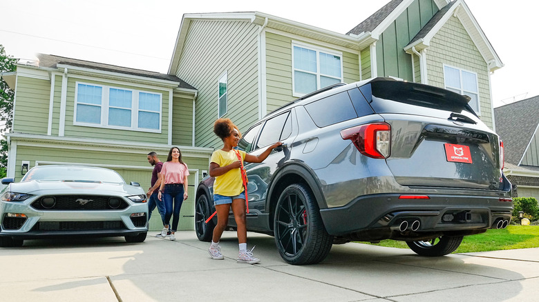 Family getting into a Ford Explorer