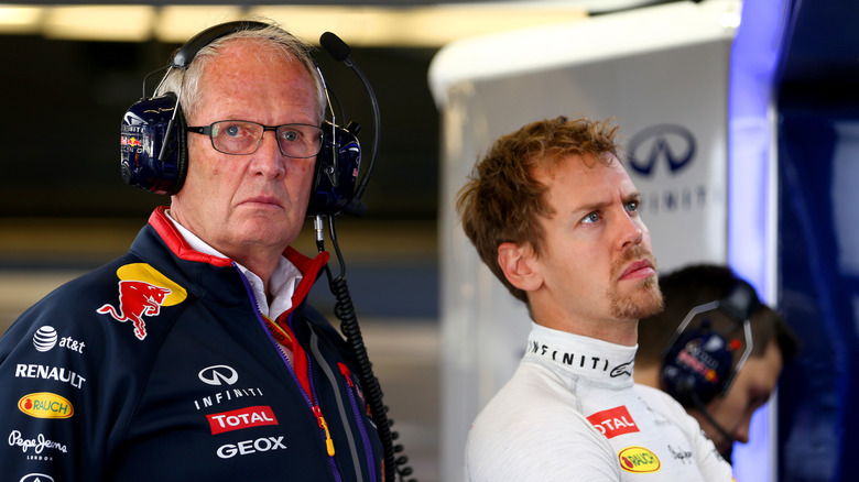 Sebastian Vettel of Germany and Infiniti Red Bull Racing looks on next to team consultant Dr Helmut Marko in the garage during practice ahead of the United States Formula One Grand Prix at Circuit of The Americas on October 31, 2014 in Austin, United States.