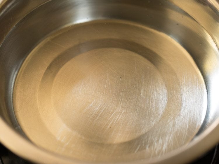 water added to a bowl for kerala style banana chips recipe. 