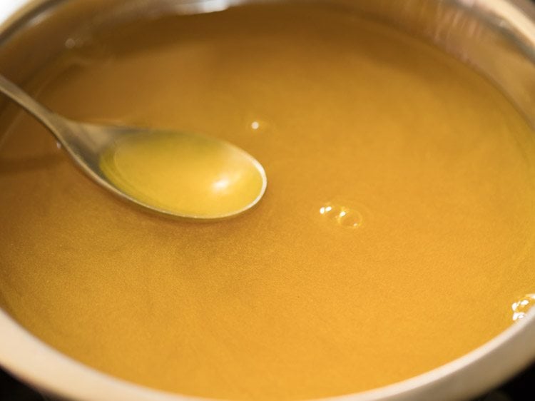 turmeric powder mixed in water for kerala style banana chips recipe. 