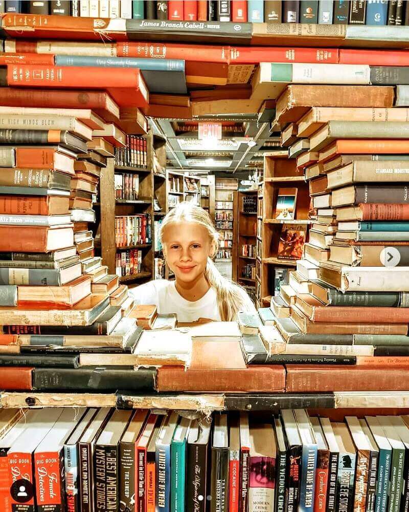 girl with head surrounded by books
