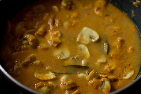 water added to mushroom masala in pan.