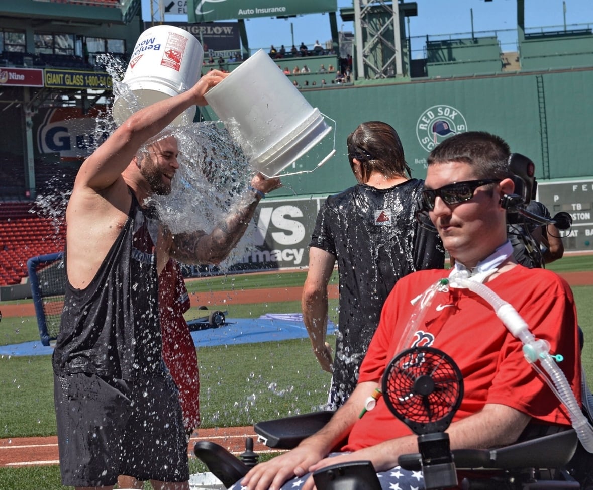 A man in a wheelchair is doused in ice