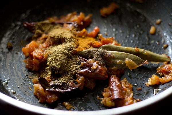 spice powders added to pan.