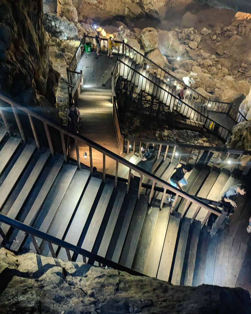 Wooden stairway into Paradise cave, illuminated with lights