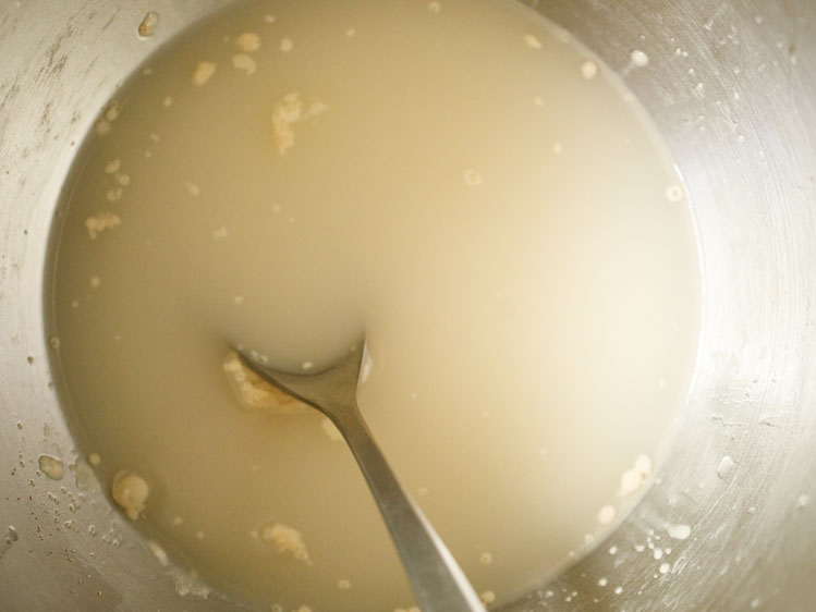 water added and mixed with spoon for pita bread recipe. 