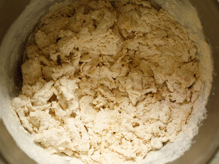 mixing everything with a wooden spoon for pita bread recipe.  