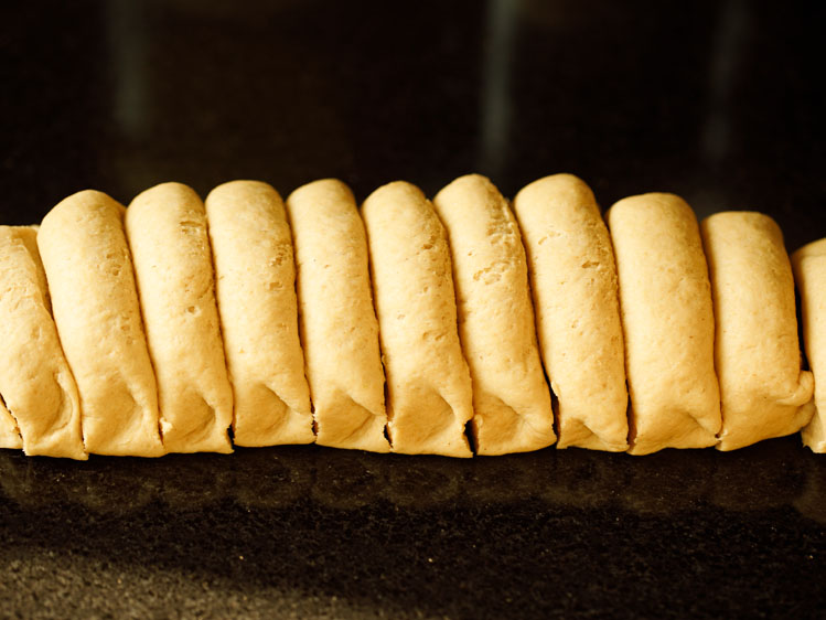 dough log sliced in equal portions for pita bread recipe. 