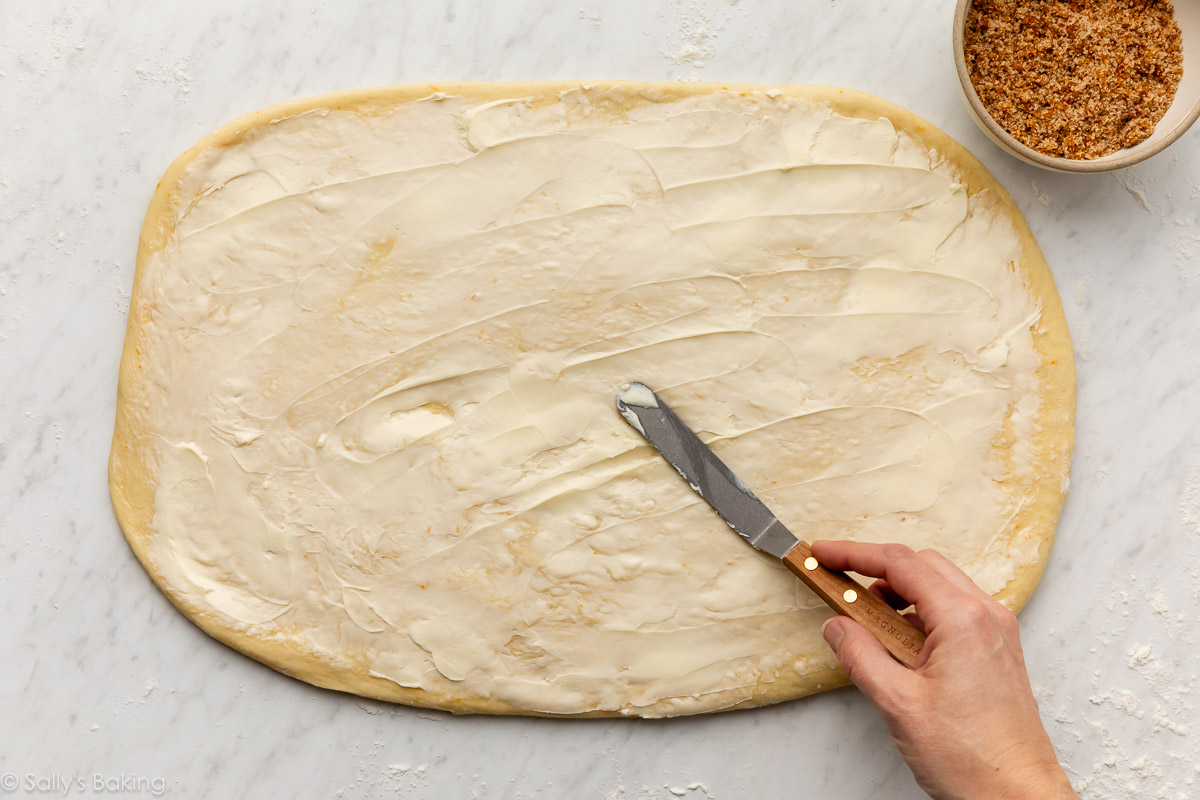 spreading butter on rolled-out dough.