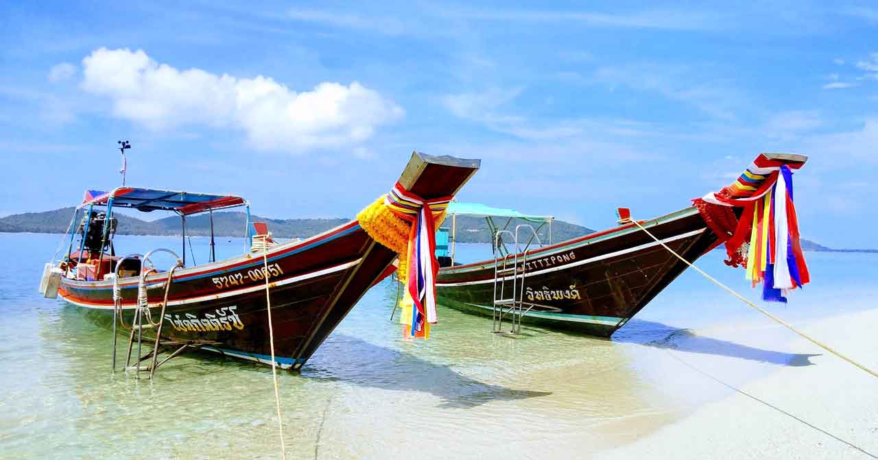Koh Madsum Pig Island longtail boats thailand. Photo by Simon Vetterli on pixabay