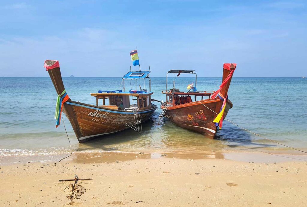 two longtail boats on klong muang beach krabi thailand
