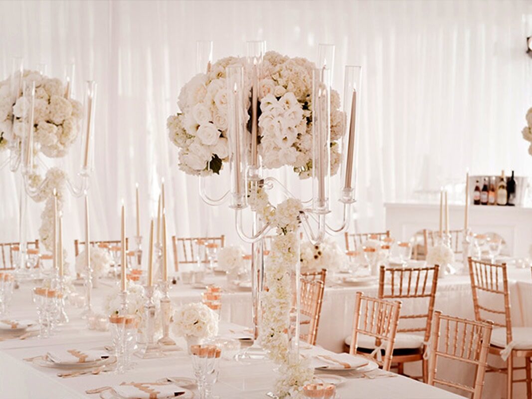 Large white bouquet of flowers, candles, drapery at indoor Houston TX wedding