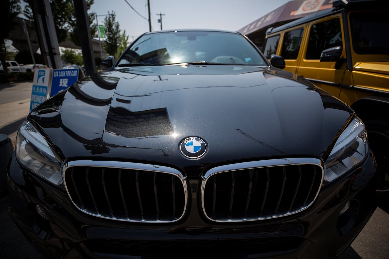 A new BMW sits in a parking lot
