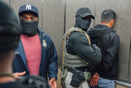 FILE - Immigration and Customs Enforcement agents escort a detained immigrant into an elevator after he exited an immigration courtroom, June 17, 2025, in New York. (AP Photo/Olga Fedorova, file) FILE - Immigration and Customs Enforcement agents escort a detained immigrant into an elevator after he exited an immigration courtroom, June 17, 2025, in New York. (AP Photo/Olga Fedorova, file)