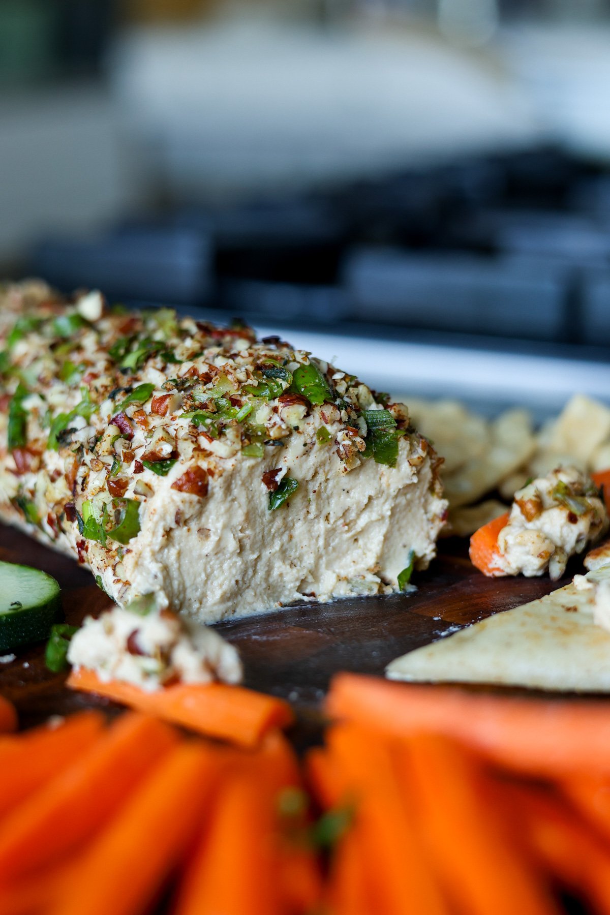 close-up of holiday cheese log after taking out some of the spread