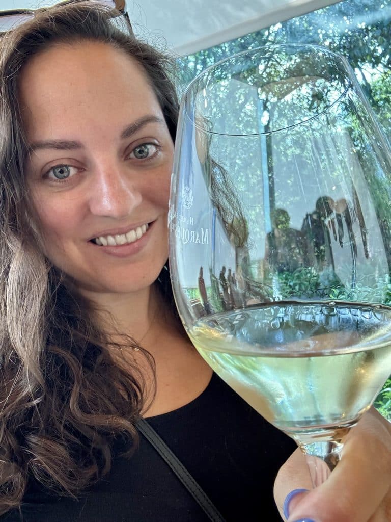 Kate drinking a glass of white wine.