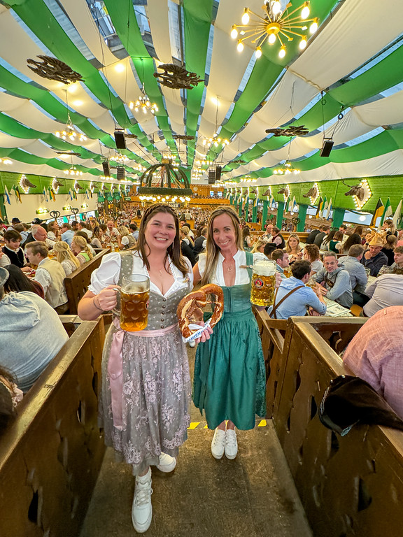 Two girls in dirndls in an Oktoberfest tent