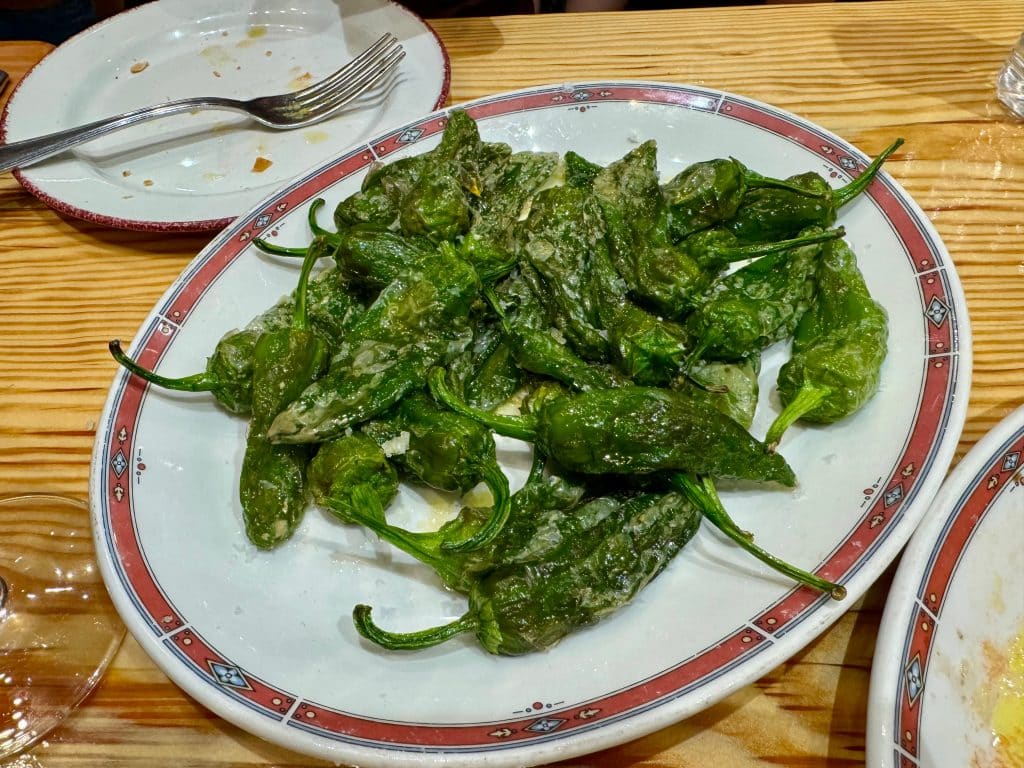 A plate of blistered padron peppers.