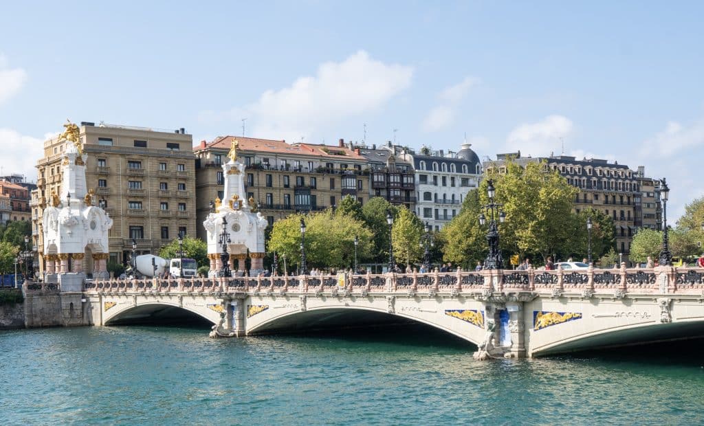 A long, crenellated bridge with decorative white monuments on each side of it.