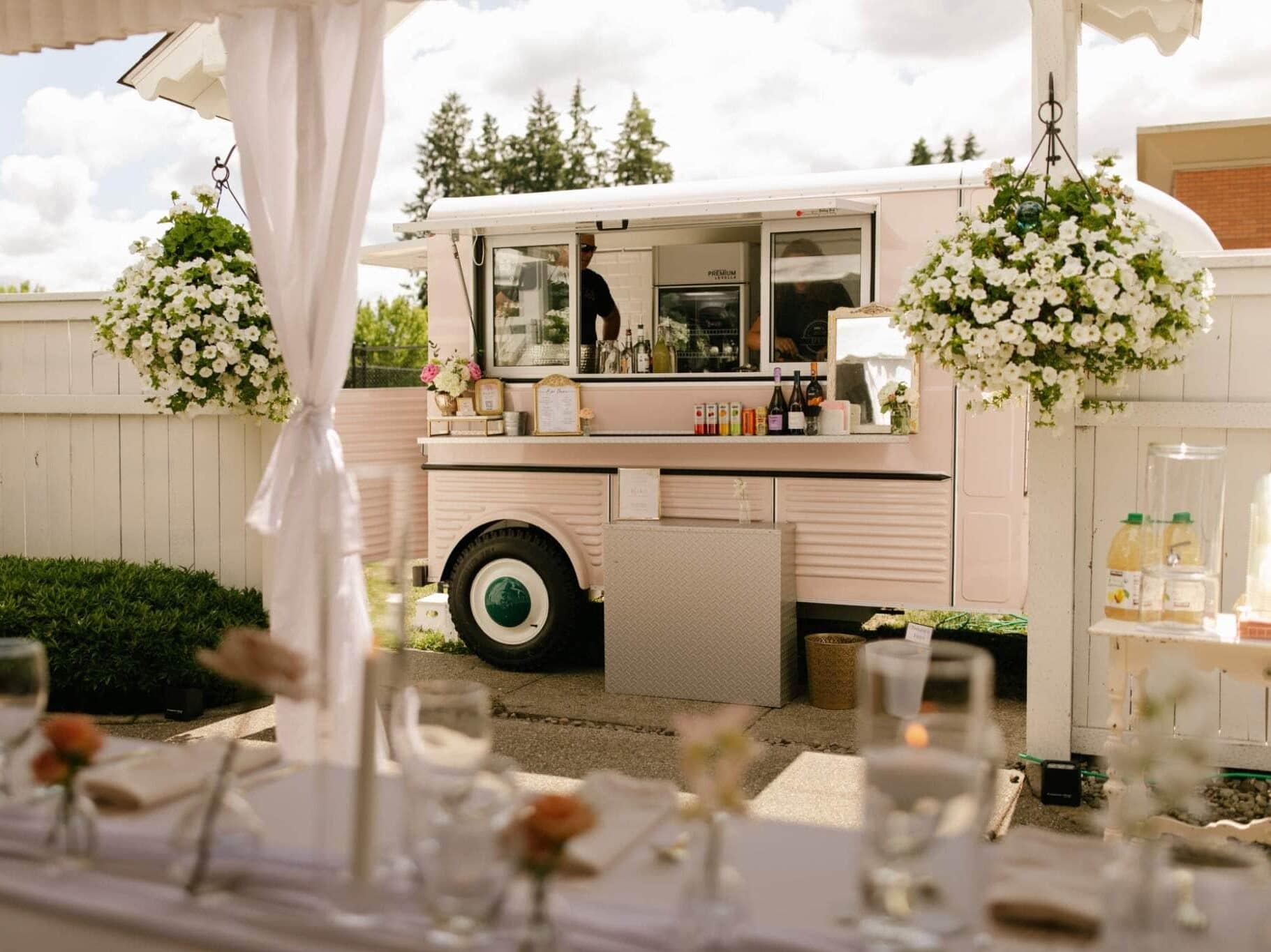 White food truck and table parked in backyard at Seattle outdoor wedding