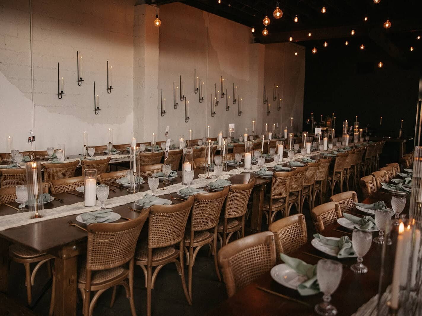 Long table with candles and place settings in Seattle wedding space